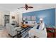 Bright living room with a decorative blue accent wall and stylish furnishings at 13190 Se 93Rd Cir, Summerfield, FL 34491