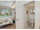 Bedroom and ensuite bath with large window overlooking manicured yard at 13190 Se 93Rd Cir, Summerfield, FL 34491