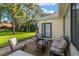 Back patio with a seating area, perfect for enjoying the lush green surroundings at 13190 Se 93Rd Cir, Summerfield, FL 34491