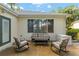 Patio area featuring a cozy seating arrangement, a table, and ample space for outdoor relaxation at 13190 Se 93Rd Cir, Summerfield, FL 34491