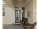 Inviting front porch area featuring a charming seating arrangement and a decorative mosaic artwork on the exterior wall at 13190 Se 93Rd Cir, Summerfield, FL 34491