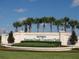 Entrance sign for Del Webb's Spruce Creek Country Club, featuring palm trees and manicured landscaping at 13190 Se 93Rd Cir, Summerfield, FL 34491