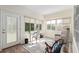 Bright sunroom featuring a desk, chair, and a cozy seating area with outdoor access at 13190 Se 93Rd Cir, Summerfield, FL 34491