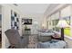 Bright sunroom featuring hardwood floors, large windows, and comfortable seating at 13190 Se 93Rd Cir, Summerfield, FL 34491
