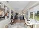 Bright sunroom featuring desk, chair, comfortable seating area, and natural light at 13190 Se 93Rd Cir, Summerfield, FL 34491