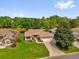Charming single-story home with a well-manicured lawn, mature trees, and a spacious driveway at 132 Palermo Pl, The Villages, FL 32159