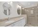 Bright bathroom with double sink vanity, quartz countertops and glass-enclosed shower at 132 Palermo Pl, The Villages, FL 32159