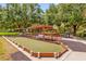 Well-maintained bocce ball courts shaded by mature trees and equipped with seating at 132 Palermo Pl, The Villages, FL 32159