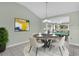 Inviting dining room with modern chandelier, neutral paint, and stylish decor at 132 Palermo Pl, The Villages, FL 32159