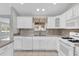 Kitchen featuring white appliances, mosaic backsplash, and ample counter space at 132 Palermo Pl, The Villages, FL 32159