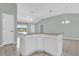 Kitchen island featuring granite countertops, white cabinets, and neutral walls at 132 Palermo Pl, The Villages, FL 32159