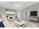 Bright living room featuring neutral paint, modern furniture, and lots of natural light at 132 Palermo Pl, The Villages, FL 32159