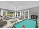 Spacious living room featuring a pool table, neutral decor, and lots of natural light at 132 Palermo Pl, The Villages, FL 32159