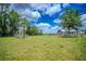 Fenced backyard offering ample room for recreation and relaxation with mature trees at 15141 Farm Rd, Groveland, FL 34736