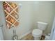 Cozy half-bathroom with a toilet and a beach-themed towel on the rack at 15141 Farm Rd, Groveland, FL 34736