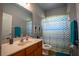 Bathroom with updated vanity, countertop and decorative shower curtain at 15141 Farm Rd, Groveland, FL 34736
