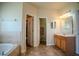 Bathroom with separate vanity and tub, offering plenty of space and privacy at 15141 Farm Rd, Groveland, FL 34736