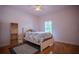 Bright bedroom with hardwood floors, area rug and ceiling fan at 15141 Farm Rd, Groveland, FL 34736