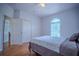 Comfortable bedroom features a ceiling fan, closet and arched window at 15141 Farm Rd, Groveland, FL 34736