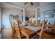 Bright dining room features wood floors and trim with decorative wreaths and dining table at 15141 Farm Rd, Groveland, FL 34736