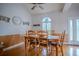 Dining room with wood table, chair, hardwood floors, and decorative stained-glass window at 15141 Farm Rd, Groveland, FL 34736