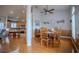 Open-concept dining area with wood floors, ceiling fan, and view of the kitchen at 15141 Farm Rd, Groveland, FL 34736