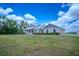 Attractive single-story home with manicured landscaping and an attached two-car garage at 15141 Farm Rd, Groveland, FL 34736