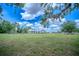 Sprawling ranch-style home on a large lot with a fenced yard and mature trees and a barn at 15141 Farm Rd, Groveland, FL 34736