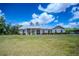 Charming single-story home with a metal roof, dormers, and a welcoming front porch at 15141 Farm Rd, Groveland, FL 34736