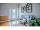 Bright foyer with decorative glass door, wood accents, and a bench for welcoming guests at 15141 Farm Rd, Groveland, FL 34736
