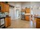 Kitchen with tile floor and stainless-steel appliances and view to adjacent dining area at 15141 Farm Rd, Groveland, FL 34736