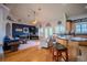 Living room with hardwood floors, a blue accent wall, with adjacent kitchen at 15141 Farm Rd, Groveland, FL 34736