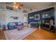 Spacious living room with hardwood floors, blue sofa, and blue accent wall with decor at 15141 Farm Rd, Groveland, FL 34736