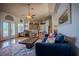 Living room with hardwood floors, blue sofa, and open view into kitchen at 15141 Farm Rd, Groveland, FL 34736