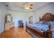Bright main bedroom features a ceiling fan and lovely hardwood floors, perfect for relaxing at 15141 Farm Rd, Groveland, FL 34736