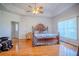 Sunny main bedroom with ample space, ceiling fan and hardwood floors for comfort at 15141 Farm Rd, Groveland, FL 34736