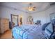 Spacious main bedroom boasts tray ceiling, fan, and en suite bathroom with walk in closet at 15141 Farm Rd, Groveland, FL 34736