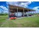 Spacious outbuilding for equipment and storage with tractor, mower and trailer at 15141 Farm Rd, Groveland, FL 34736