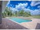 Inviting swimming pool surrounded by a brick patio, perfect for outdoor relaxation at 15141 Farm Rd, Groveland, FL 34736