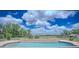 Beautiful swimming pool with a cascading water feature and a fenced-in backyard at 15141 Farm Rd, Groveland, FL 34736