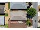 Aerial view of rooftops and neighborhood street shows landscaping and mature trees at 1667 Osprey Ave, The Villages, FL 32162