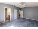 Spacious bedroom with neutral gray walls, carpet flooring, and two entryways at 1667 Osprey Ave, The Villages, FL 32162