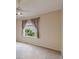 Bright bedroom with neutral walls, carpet, and a window looking to the yard at 1667 Osprey Ave, The Villages, FL 32162