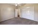 Bedroom with neutral walls, carpet, closet, and doorways at 1667 Osprey Ave, The Villages, FL 32162