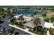 Aerial view of community clubhouse and pool area with palm trees and ample parking at 1667 Osprey Ave, The Villages, FL 32162