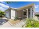 Exterior showcasing a one-car garage, screened-in lanai with neutral gravel landscaping, and a walkway that wraps around the home at 1667 Osprey Ave, The Villages, FL 32162