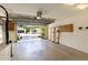 Open garage with shelving, epoxy floors, and a view of the backyard at 1667 Osprey Ave, The Villages, FL 32162