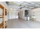 Clean garage with sink, shelving, and lots of space for storage at 1667 Osprey Ave, The Villages, FL 32162