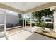 The screened-in lanai offering lovely views of the neighborhood landscaping and nearby homes at 1667 Osprey Ave, The Villages, FL 32162