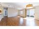 Spacious living room with hardwood floors, ceiling fan, sliding glass doors to the lanai, and neutral wall color at 1667 Osprey Ave, The Villages, FL 32162